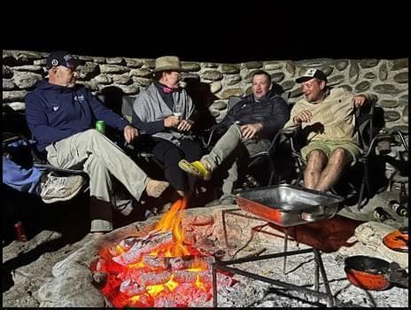 Travelers gathering around a campfire in the Cederberg mountains at night