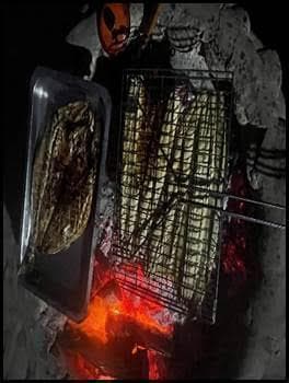 Campfire cooking on the beach during wild camping experience