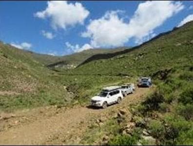 4x4 vehicles parked on scenic mountain pass