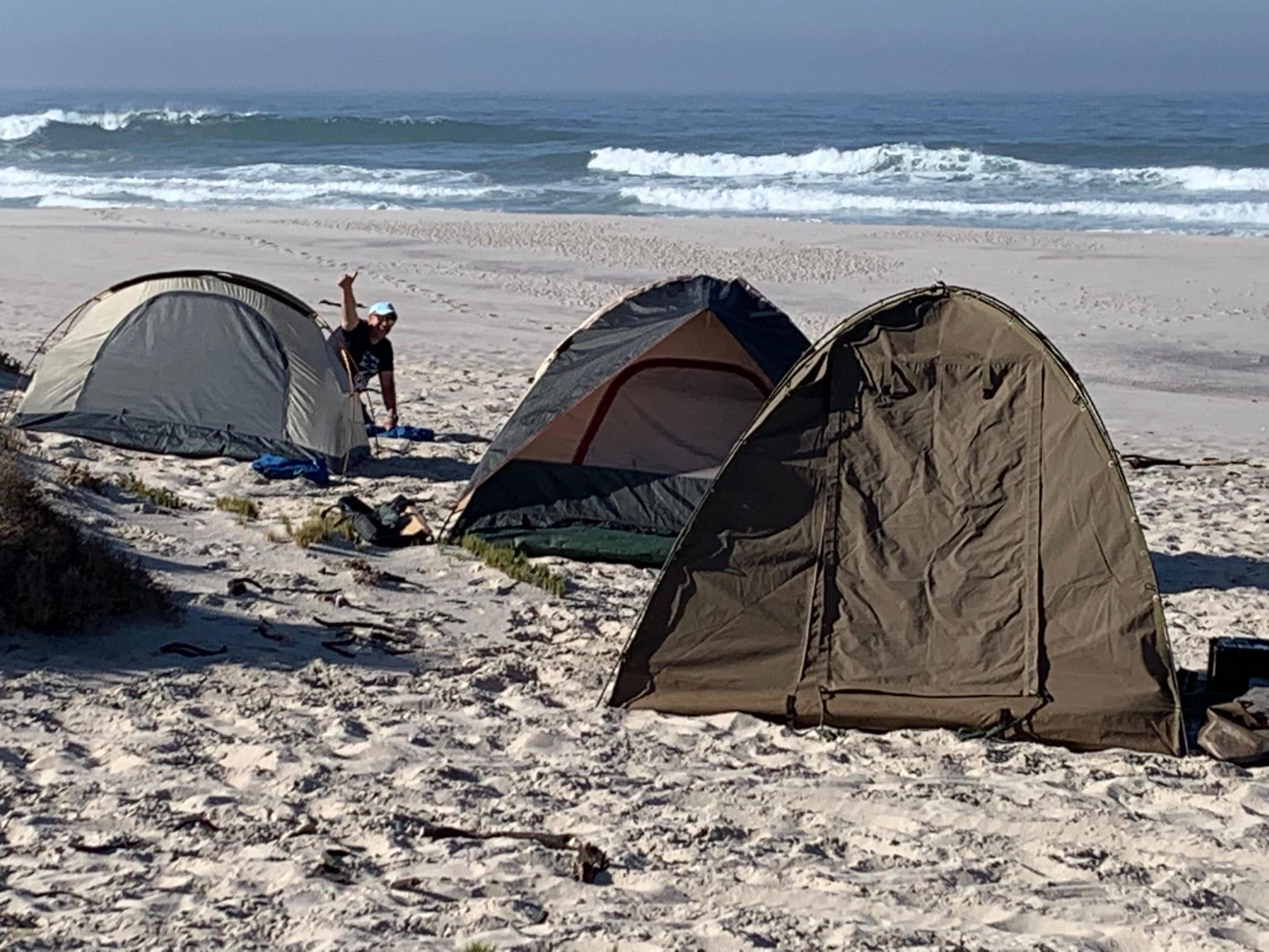 Tents pitched on the pristine Namakwa National Park beach with ocean waves