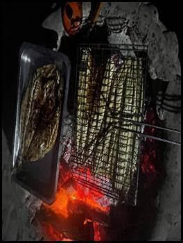 Campfire cooking on the beach during wild camping experience