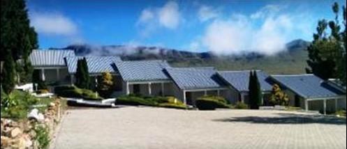 Mountain Shadow Hotel exterior with mountains
