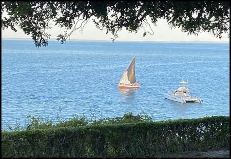 Traditionele dhow-zeilboot en motorboot op de kalme Indische Oceaan